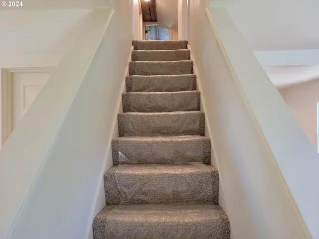a view of staircase with white walls
