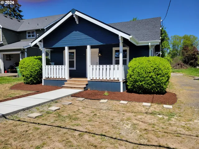 a front view of a house with a garden