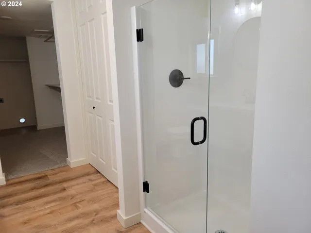 a bathroom with a glass shower door