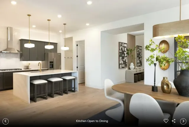 a large kitchen with kitchen island a dining table and chairs