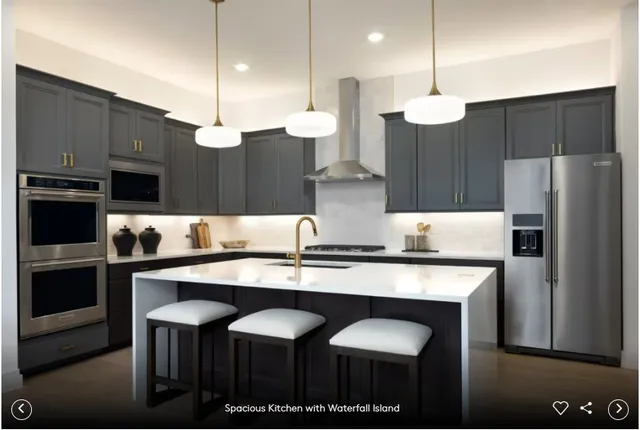 a kitchen with stainless steel appliances granite countertop a sink a stove and refrigerator