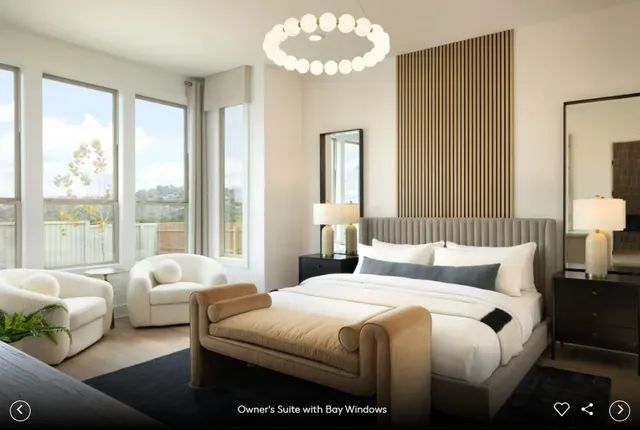 a bedroom with bed and a large window