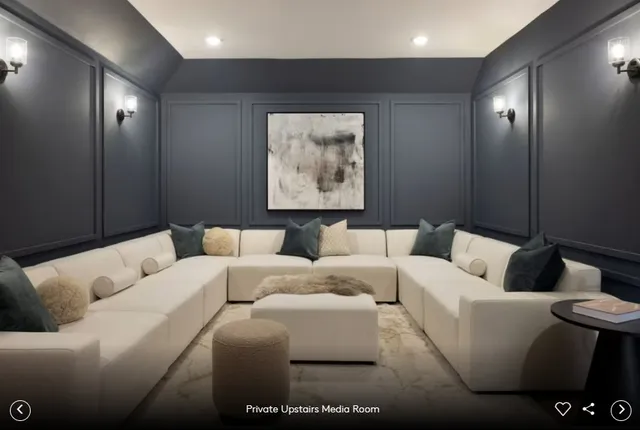 a living room with furniture and a large mirror