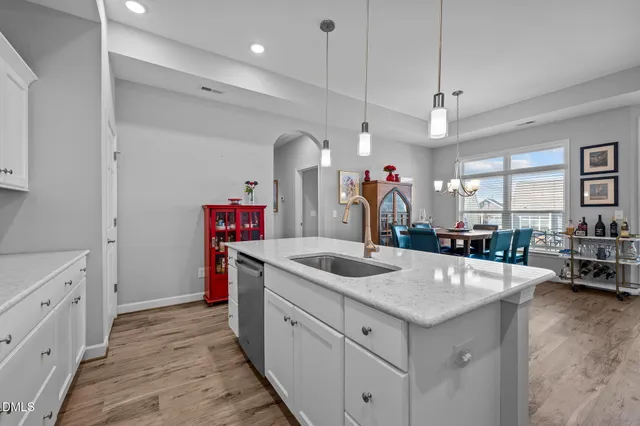 a kitchen with kitchen island a sink stove and wooden floor