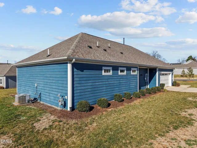 a backyard of a house with dishwasher and wooden fence