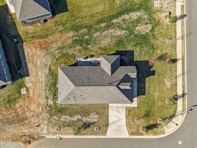 an aerial view of a house with a yard