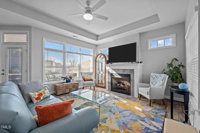a living room with furniture a fireplace and a flat screen tv