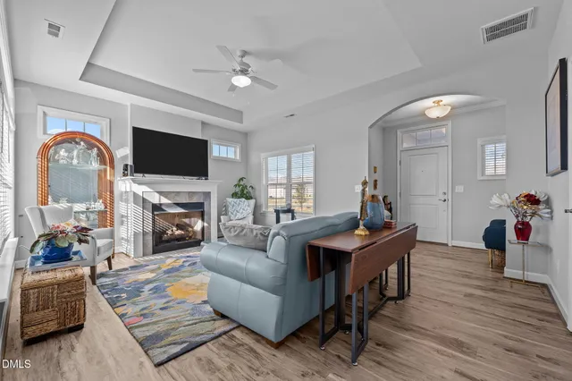 a living room with furniture a fireplace and a flat screen tv