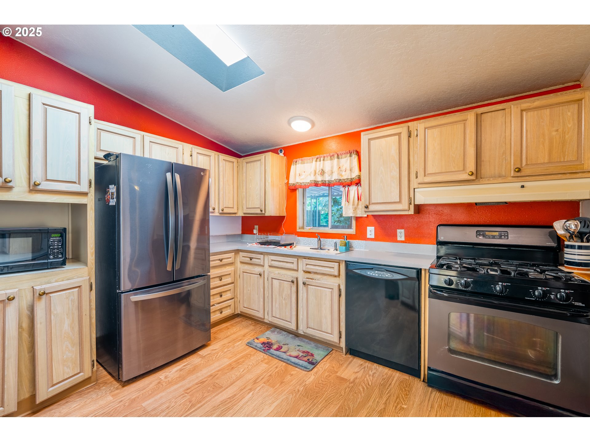 5064 Silver Loop Northeast Salem, OR 97305 - Photo 12 of 27 a kitchen with stainless steel appliances granite countertop a refrigerator a stove a sink and a microwave