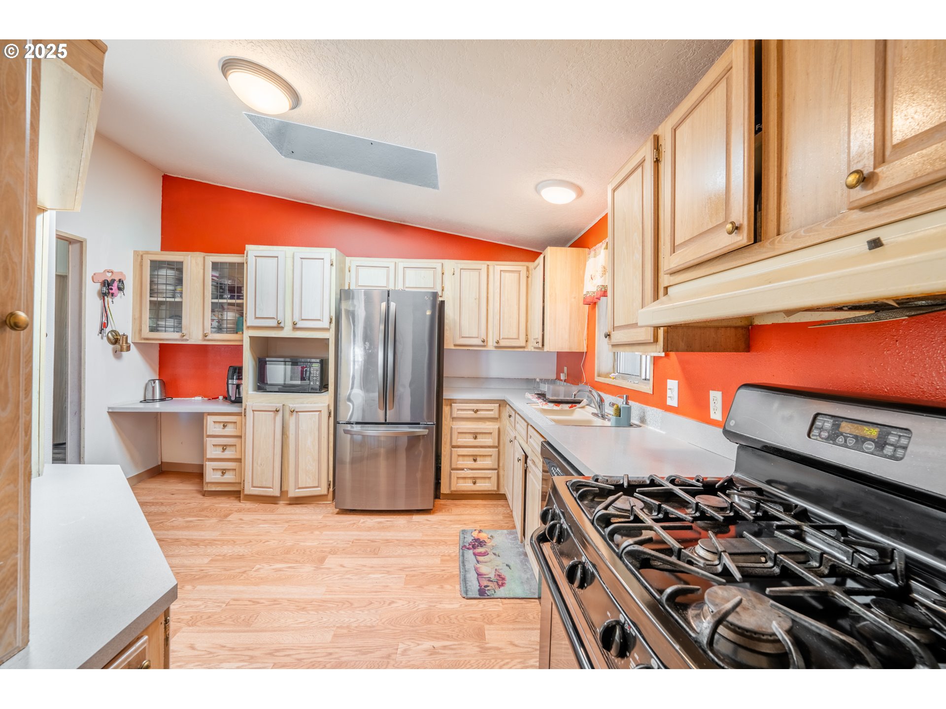 5064 Silver Loop Northeast Salem, OR 97305 - Photo 13 of 27 a kitchen with stainless steel appliances kitchen island granite countertop a stove and a refrigerator
