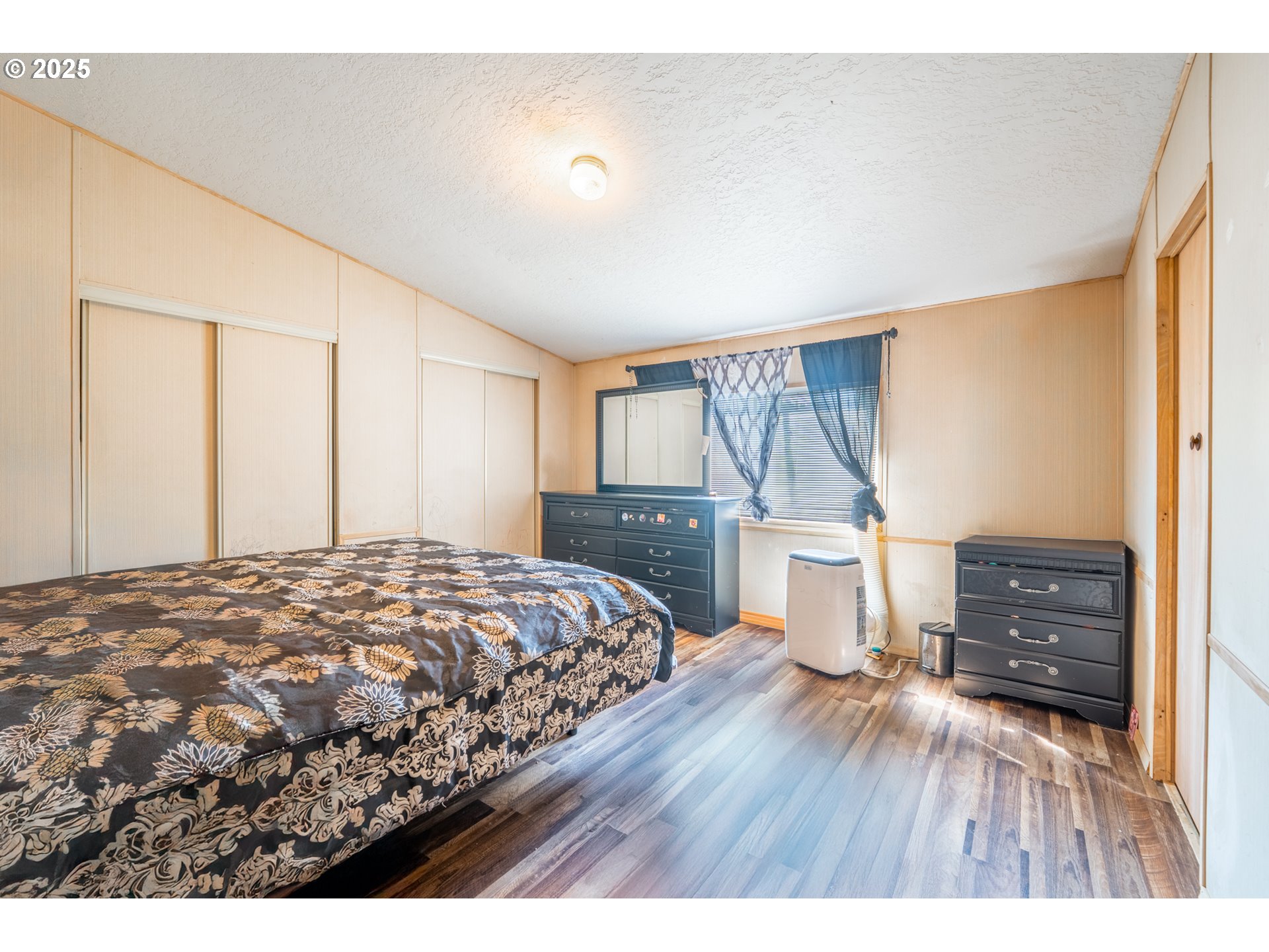 5064 Silver Loop Northeast Salem, OR 97305 - Photo 18 of 27 a bedroom with a bed and wooden floor