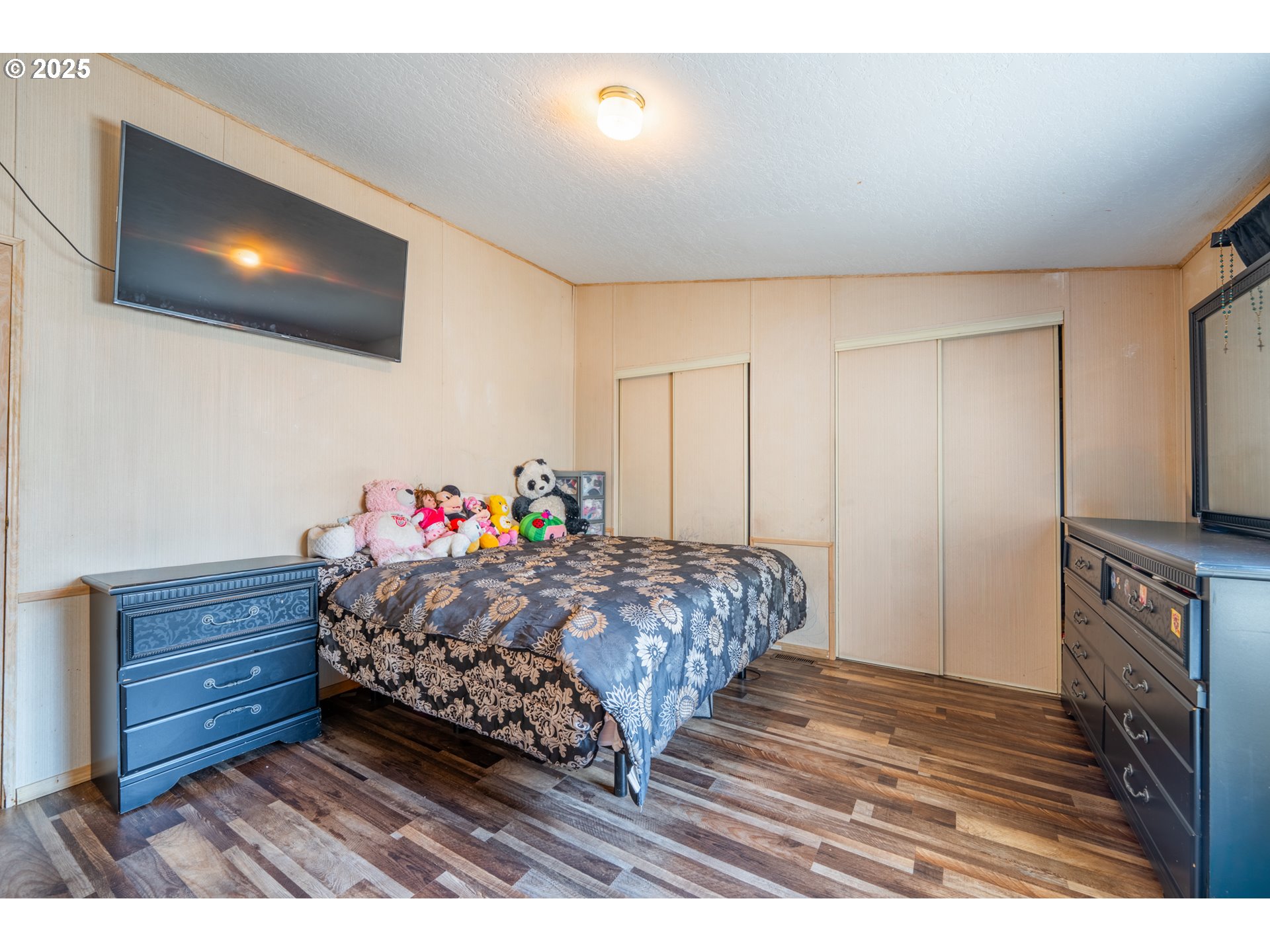 5064 Silver Loop Northeast Salem, OR 97305 - Photo 19 of 27 a bed room with a bed window and a flat screen tv