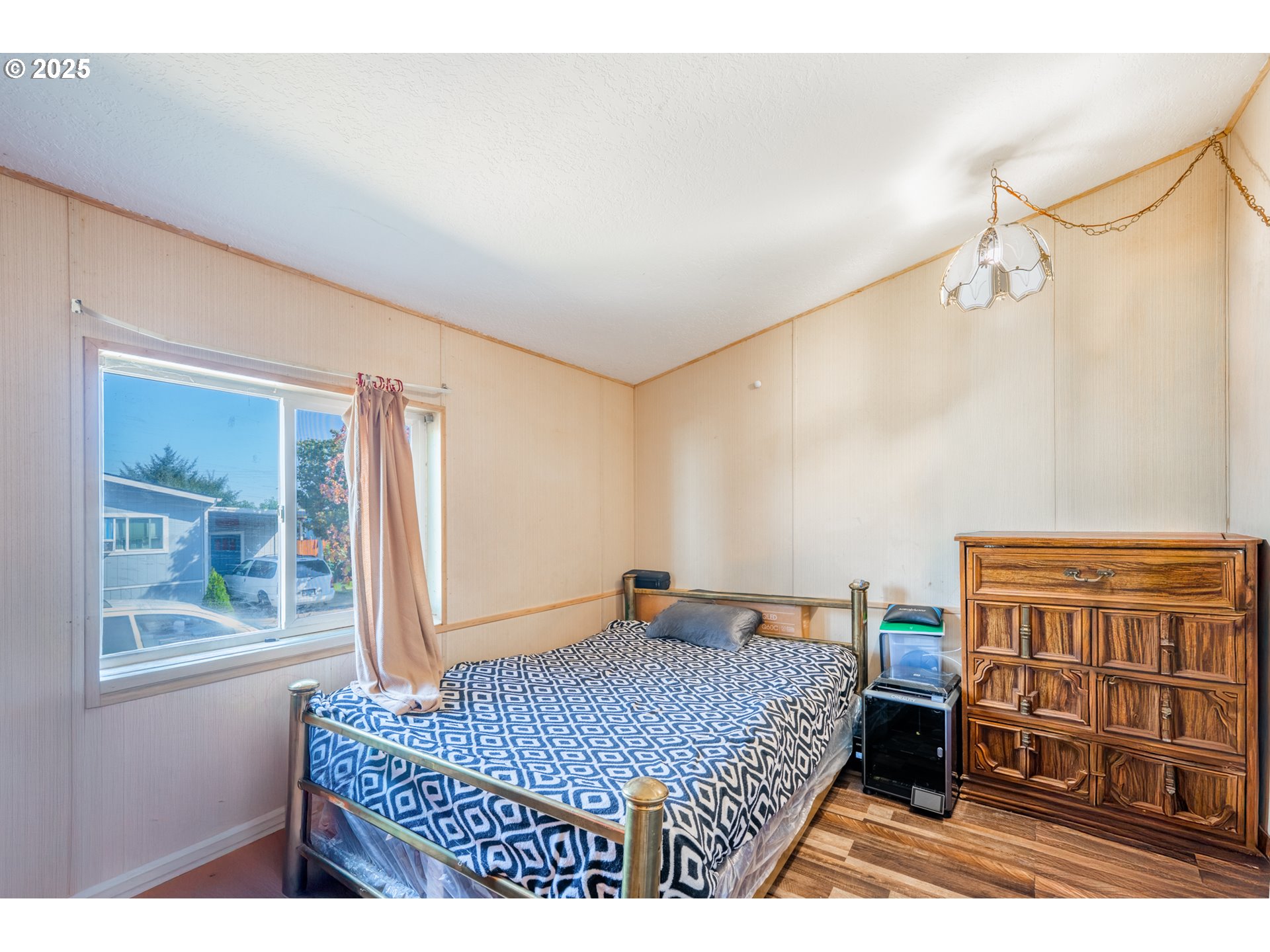 5064 Silver Loop Northeast Salem, OR 97305 - Photo 21 of 27 a bedroom with a bed a dresser and a window