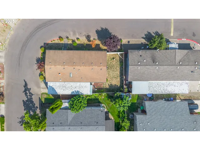 an aerial view of a house with a yard and black garden