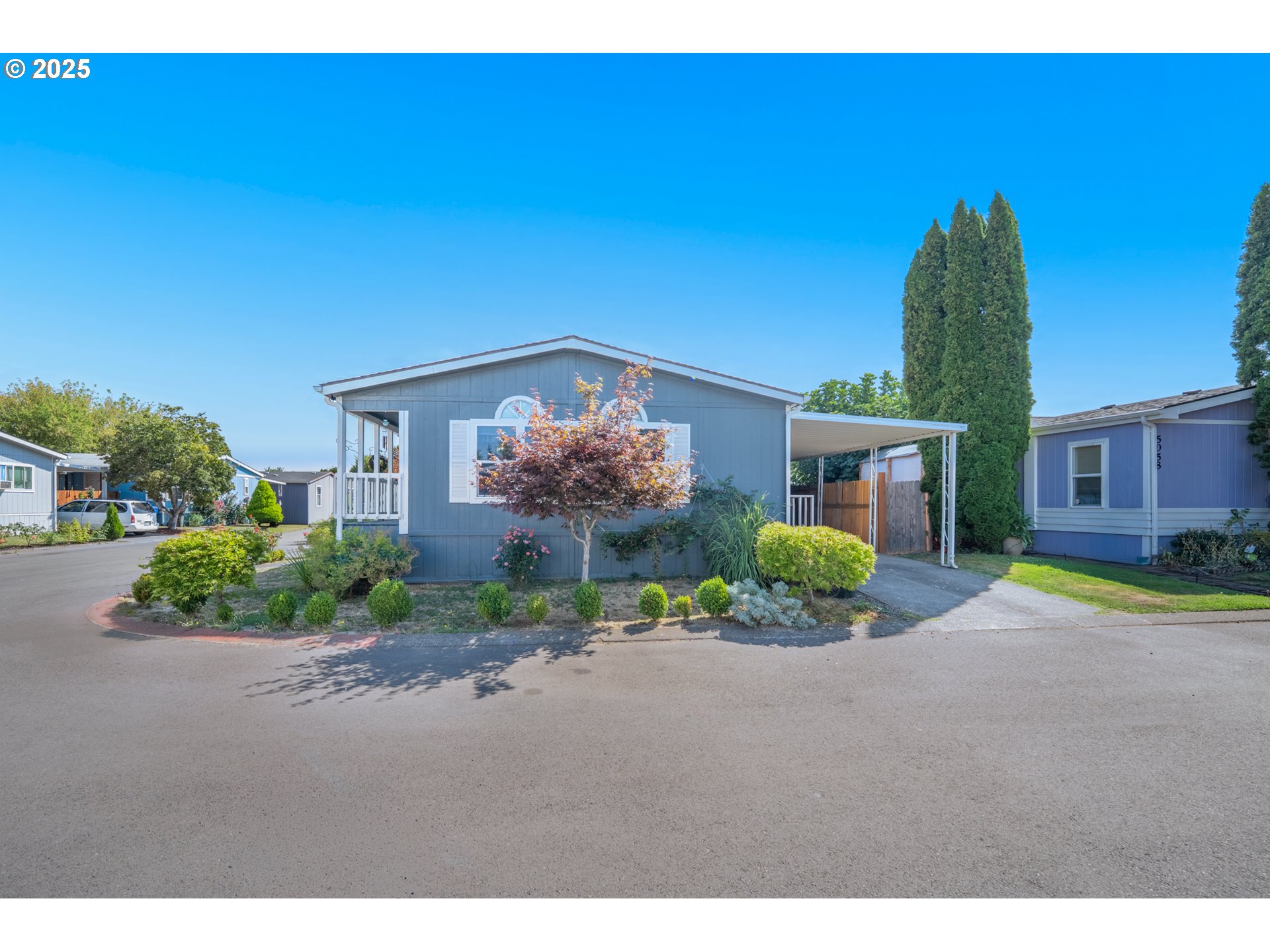 5064 Silver Loop Northeast Salem, OR 97305 - Photo 3 of 27 a front view of a house with a yard and shrubs