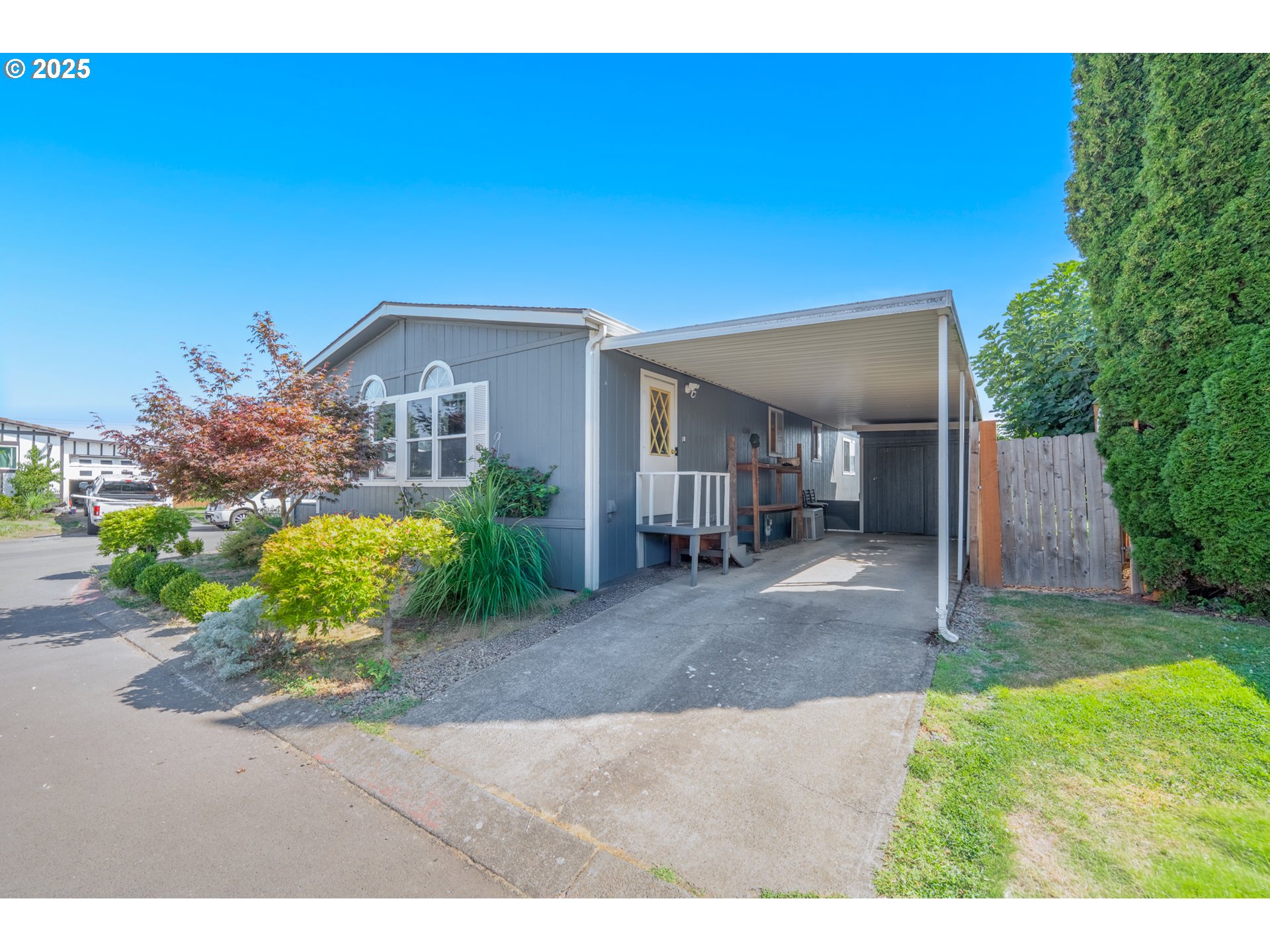 5064 Silver Loop Northeast Salem, OR 97305 - Photo 4 of 27 a view of a house with potted plants and a large tree
