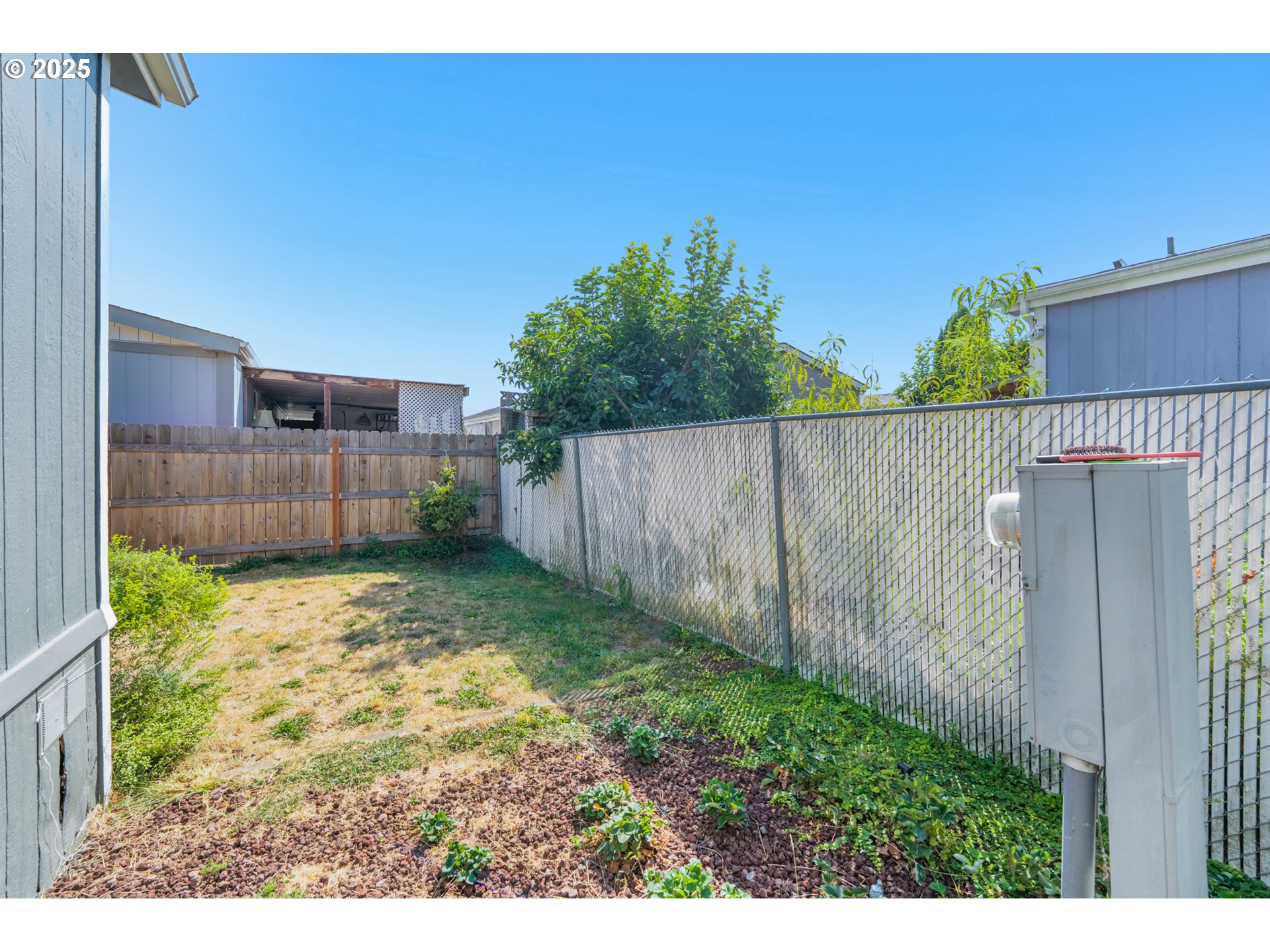 5064 Silver Loop Northeast Salem, OR 97305 - Photo 5 of 27 a backyard of a house with a small yard and wooden fence