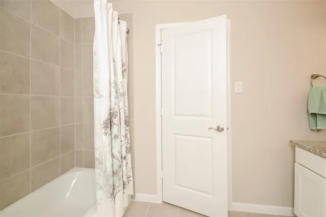 a bathroom with a bathtub and shower