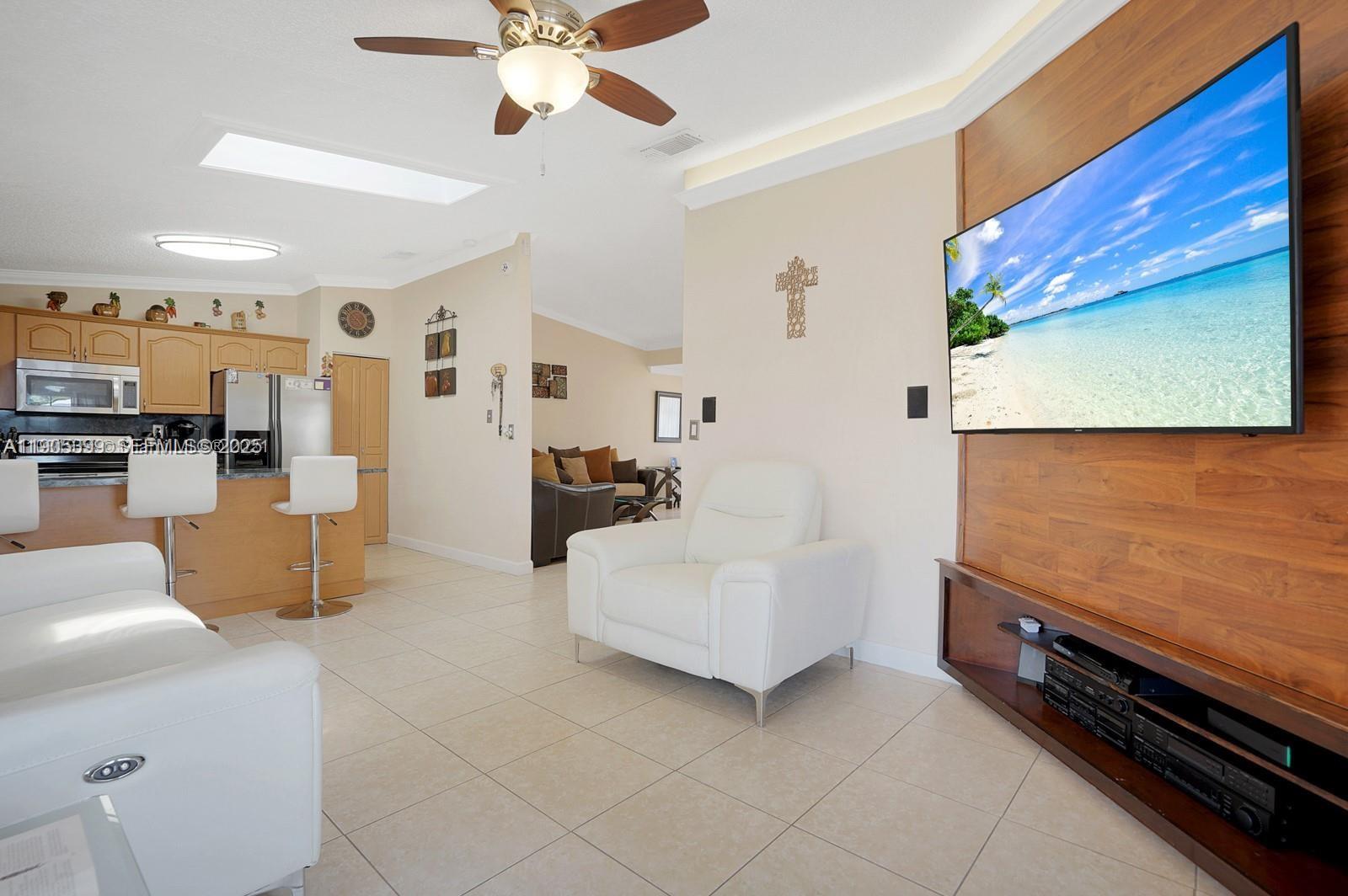 6103 Southwest 130th Avenue Miami, FL 33183 - Photo 7 of 9 a living room with furniture and kitchen view