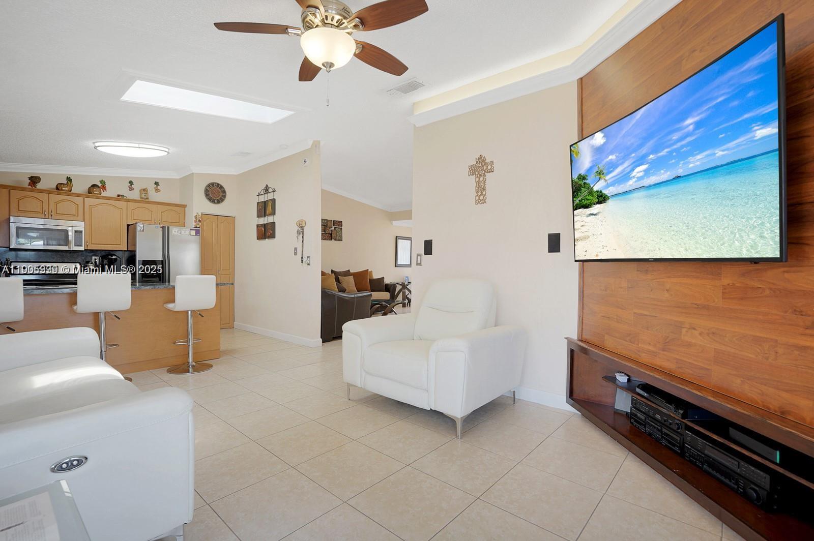 6103 Southwest 130th Avenue Miami, FL 33183 - Photo 7 of 9 a living room with furniture and kitchen view