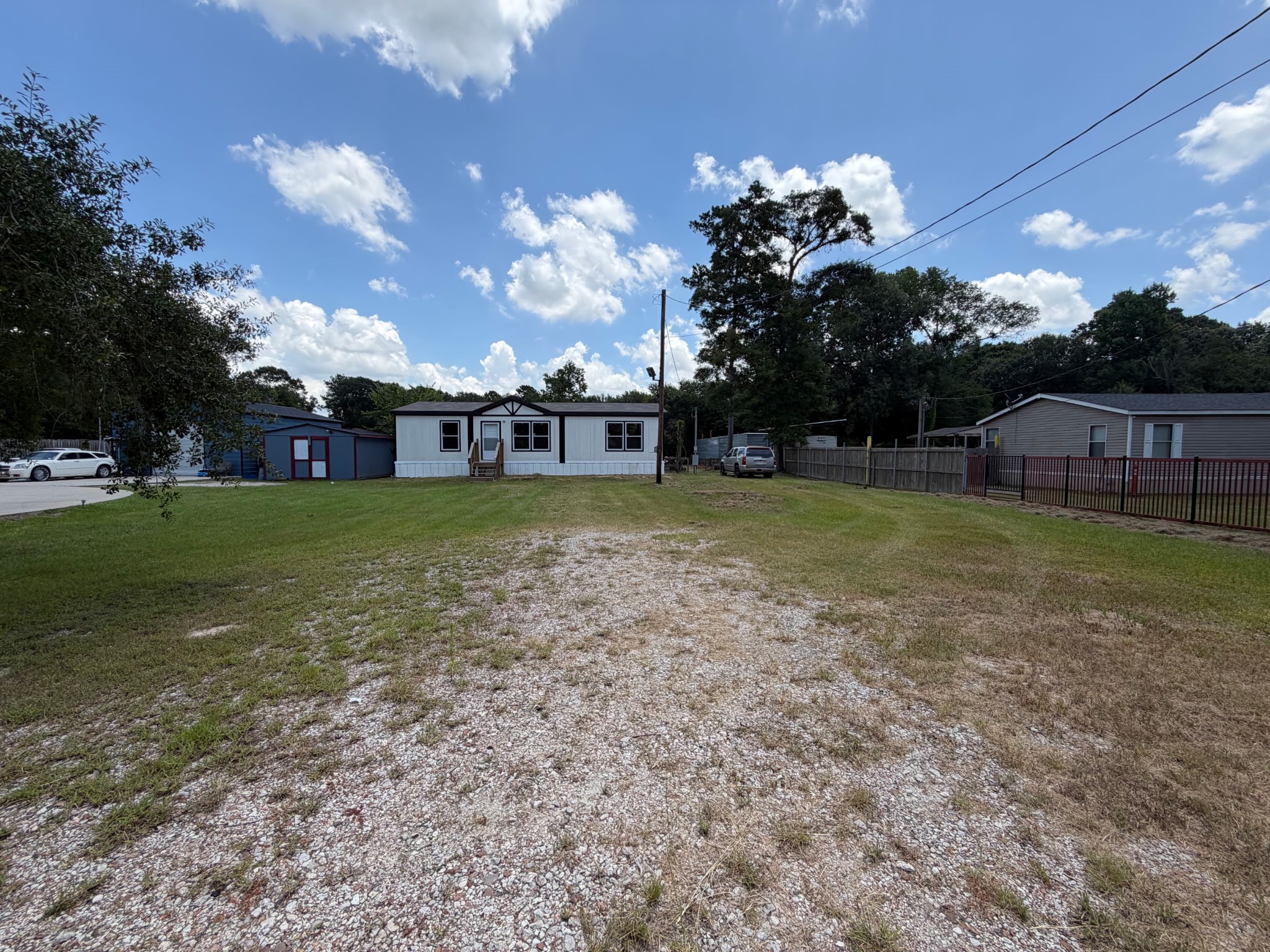 15955 Westgate Road Splendora, TX 77372 - Photo 2 of 14 a view of a house with swimming pool and a yard