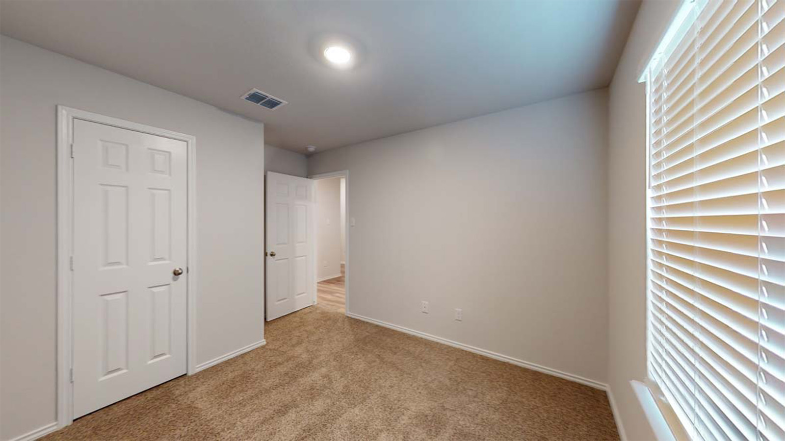 1418 Victory Rnch Trail Killeen, TX 76549 - Photo 16 of 22 A well-lit room offers fresh carpeting and natural light through large windows.