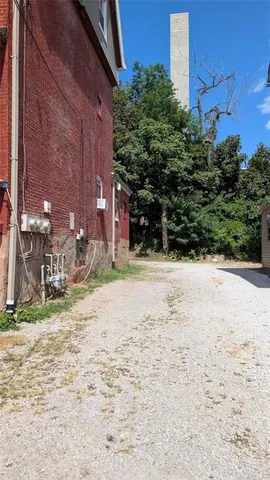 a pathway of a house with a yard