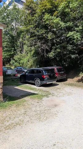 a view of backyard with a car parked