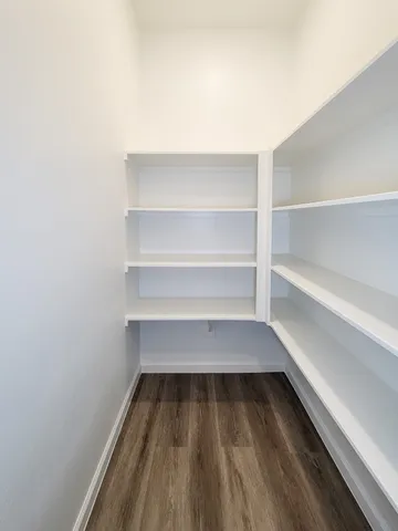 a view of walk in closet with empty racks