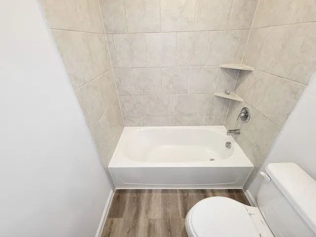 a bathroom with a sink a toilet and bathtub