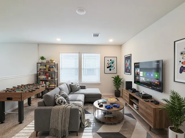 a living room with furniture a flat screen tv and a large window