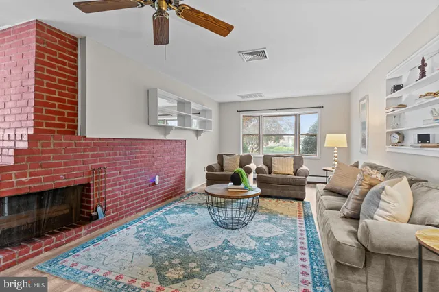 a living room with furniture windows and a fireplace