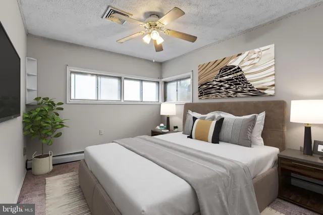 a bedroom with a large bed and a chandelier
