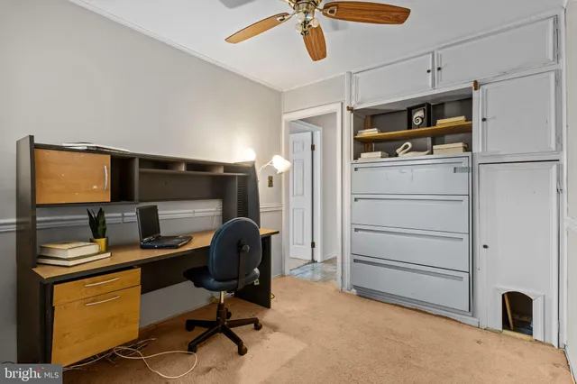 a bedroom with a workspace