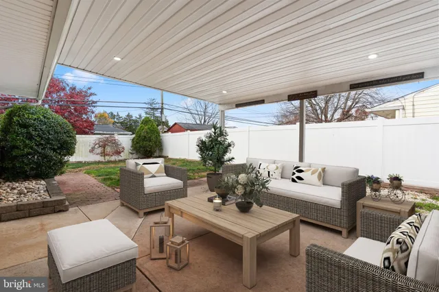 a living room with furniture and flowers