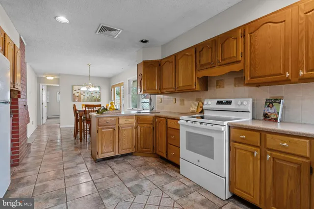 a kitchen with a sink cabinets and window