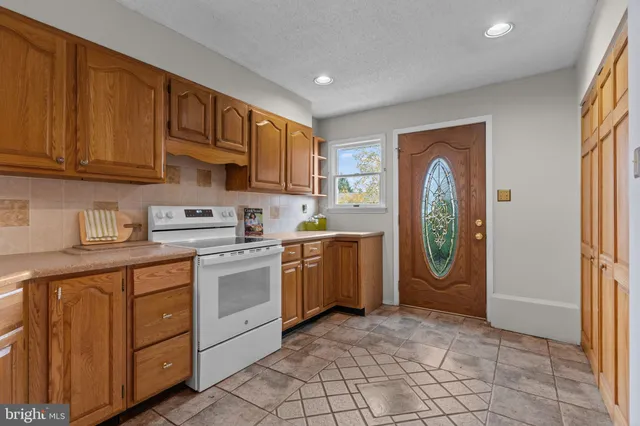 a kitchen with cabinets and window