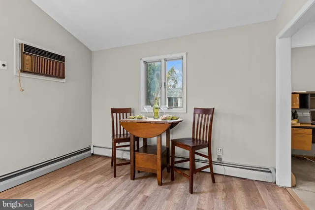 a dining room with furniture and wooden floor