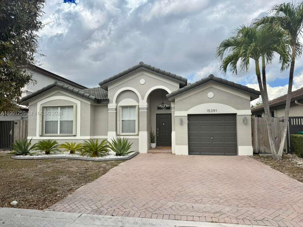15391 Southwest 17th Terrace Miami, FL 33185 - Photo 1 of 16 a view of a house with a yard and potted plants