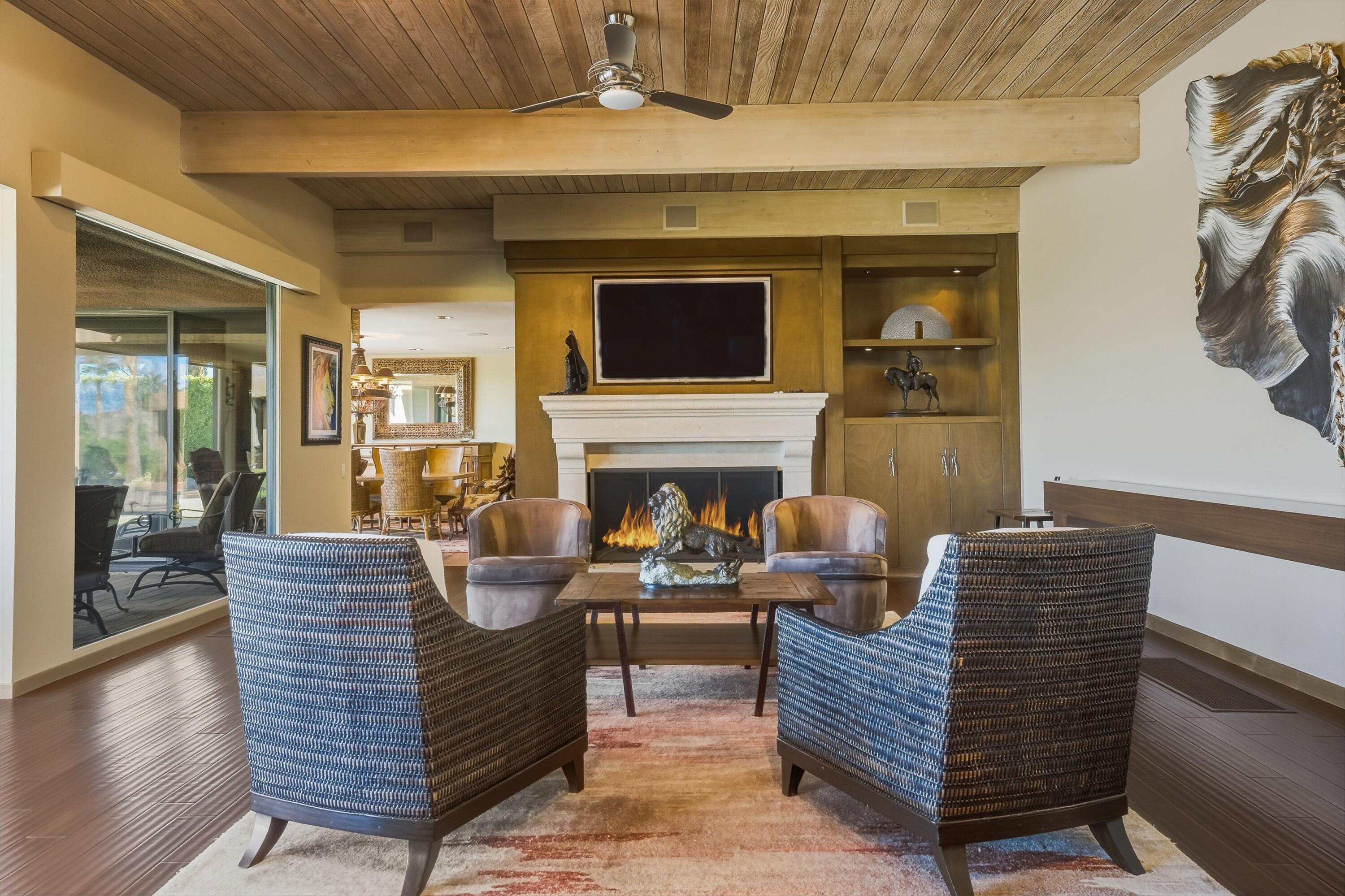70150 Thunderbird Road Rancho Mirage, CA 92270 - Photo 19 of 67 a living room with furniture a flat screen tv and a fireplace