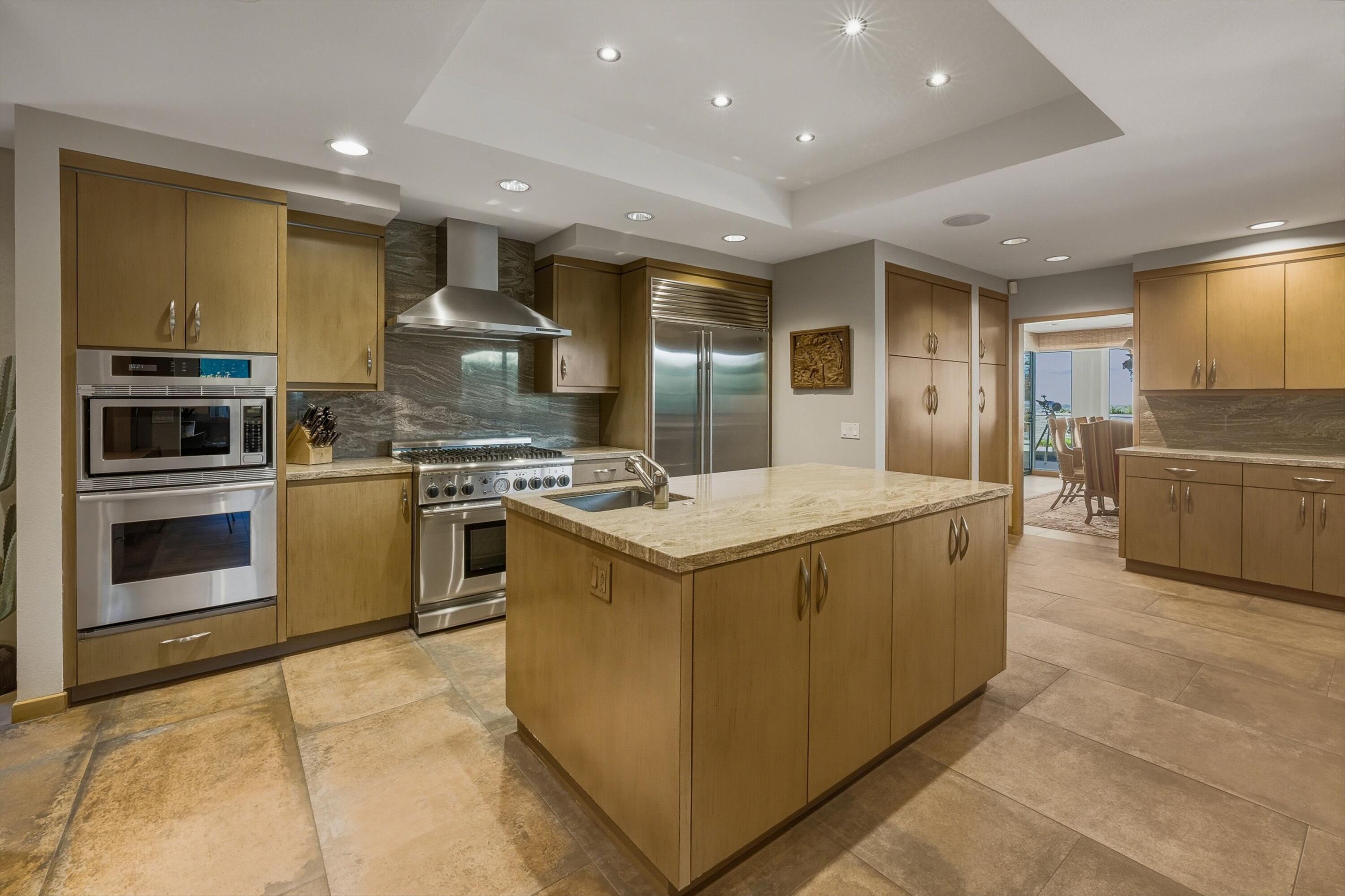 70150 Thunderbird Road Rancho Mirage, CA 92270 - Photo 24 of 67 a kitchen with stainless steel appliances granite countertop a stove and a refrigerator