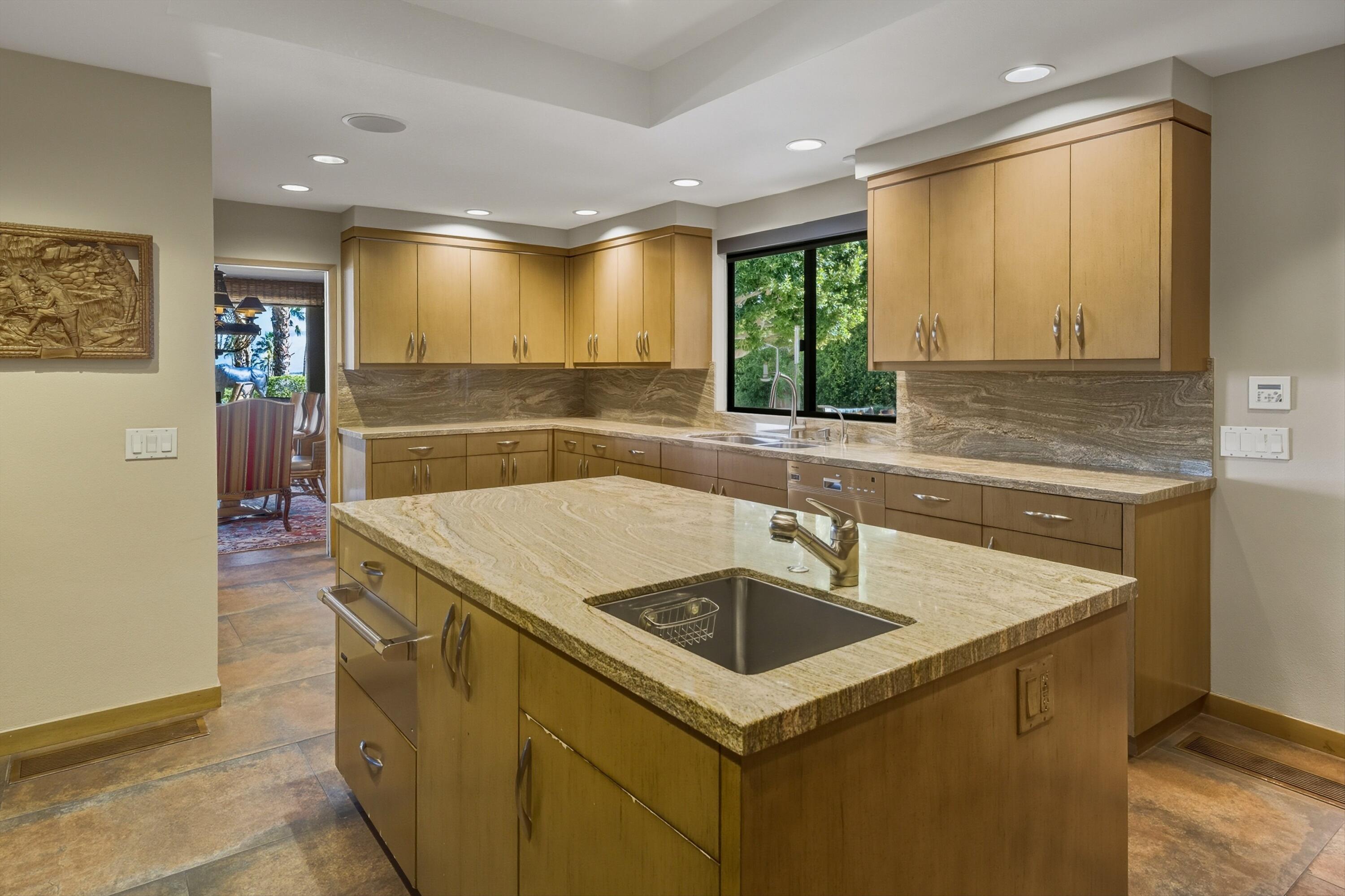 70150 Thunderbird Road Rancho Mirage, CA 92270 - Photo 26 of 67 a kitchen with a sink and a refrigerator