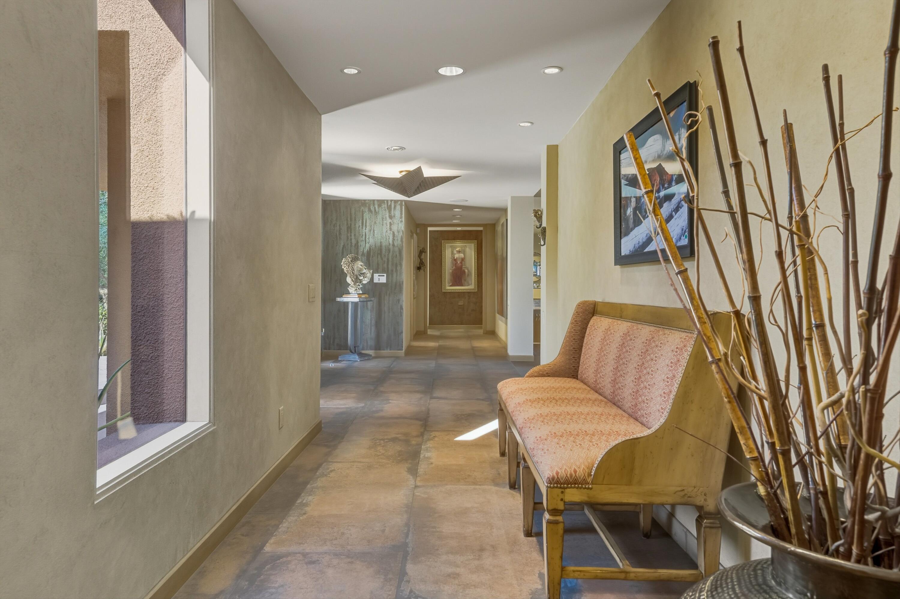 70150 Thunderbird Road Rancho Mirage, CA 92270 - Photo 31 of 67 a living room with furniture and a painting on the wall