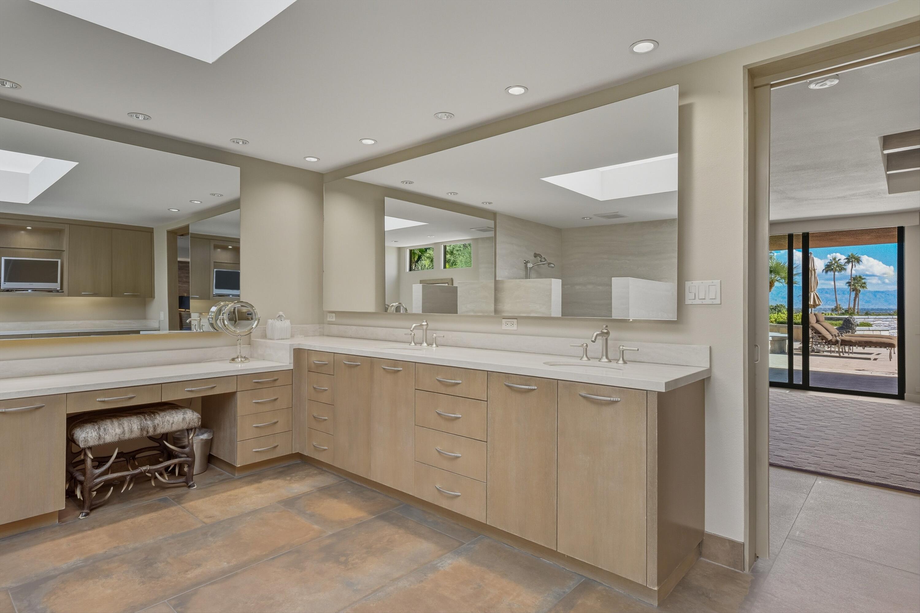 70150 Thunderbird Road Rancho Mirage, CA 92270 - Photo 40 of 67 a spacious bathroom with a sink and a mirror