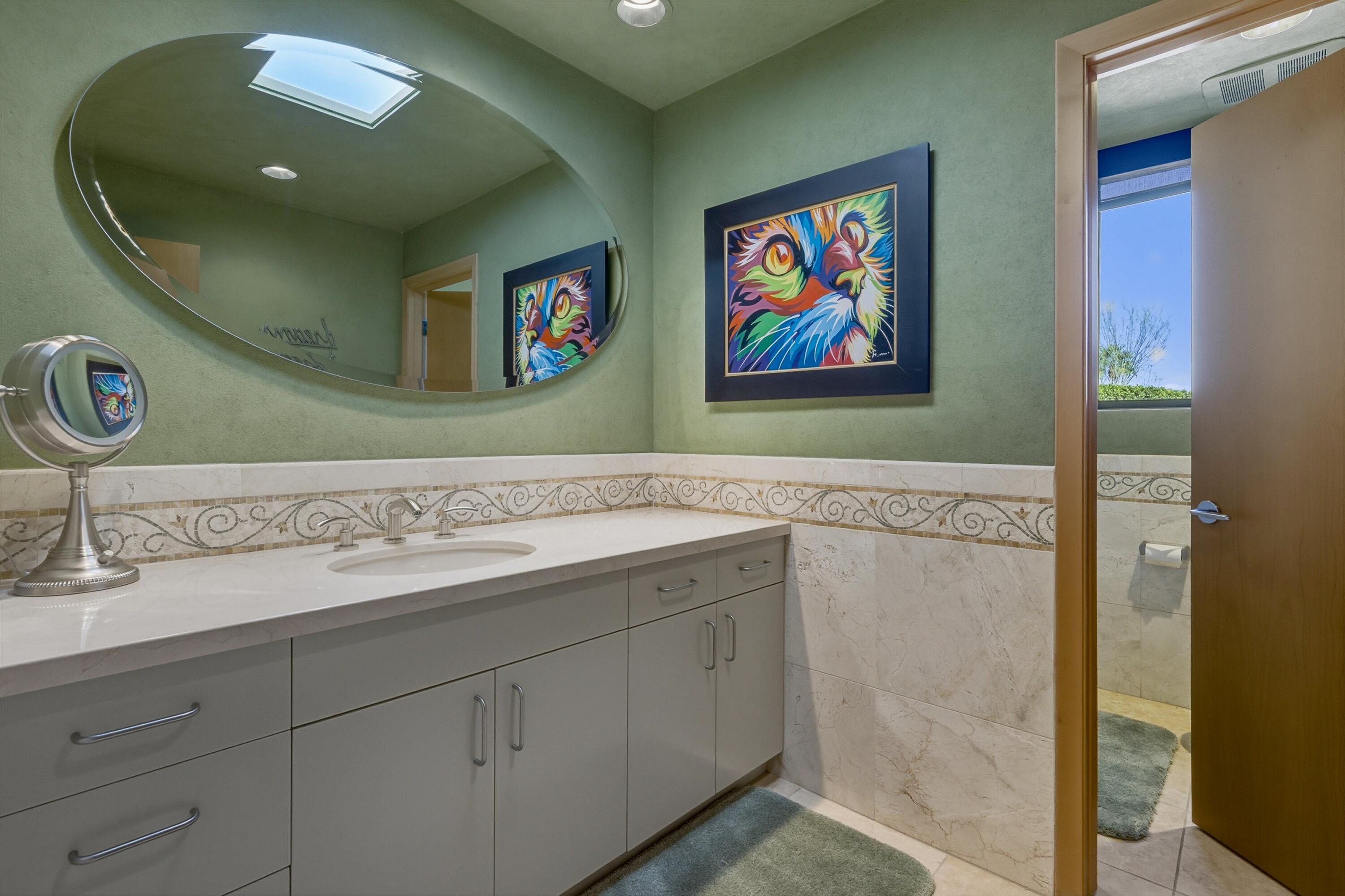 70150 Thunderbird Road Rancho Mirage, CA 92270 - Photo 48 of 67 a bathroom with a sink a vanity and a mirror