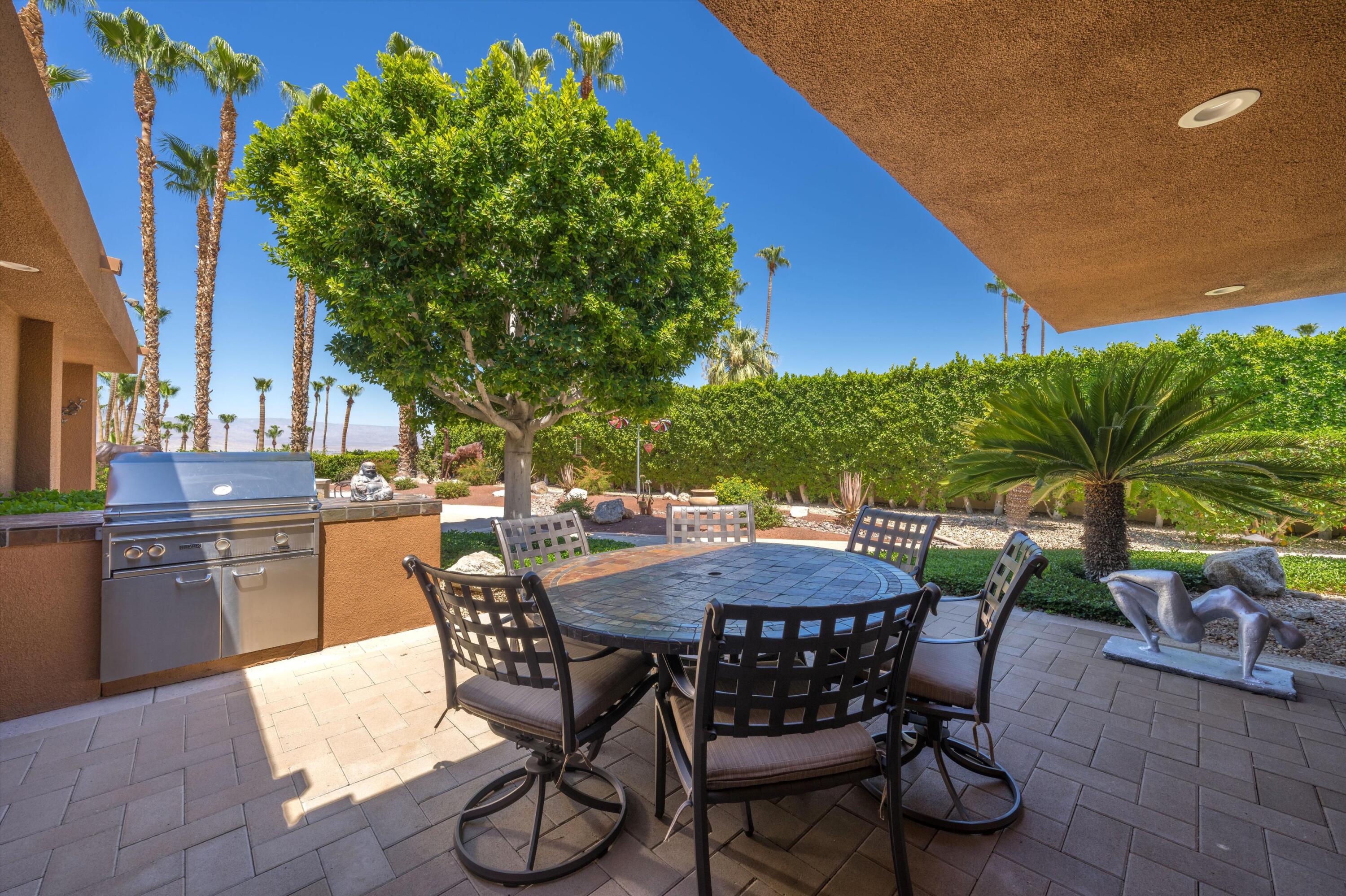 70150 Thunderbird Road Rancho Mirage, CA 92270 - Photo 60 of 67 a patio with a table and chairs and potted plants