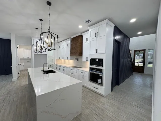 a view of kitchen with sink and refrigerator
