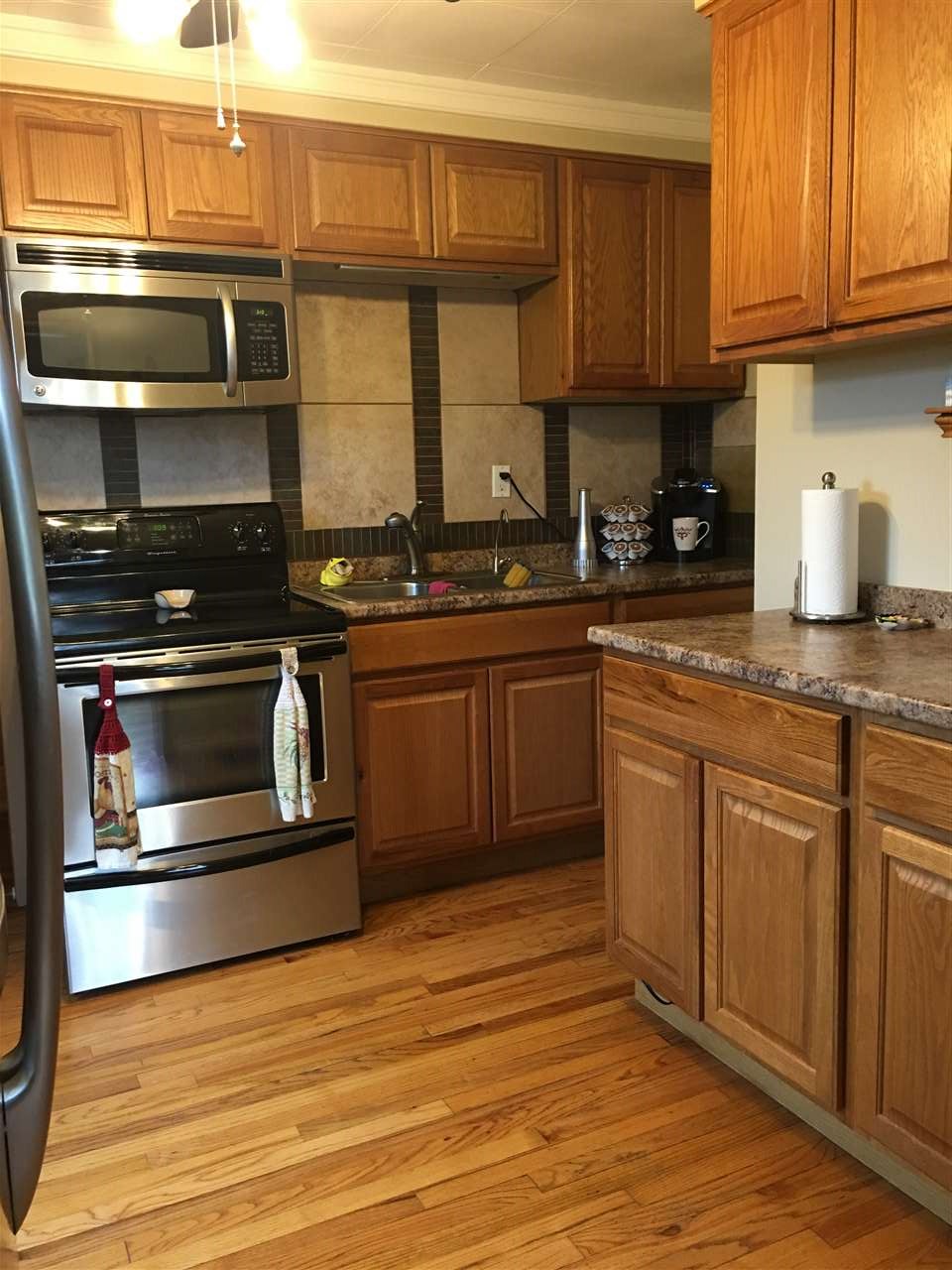 609 Barry Road Rockford, IL 61109 - Photo 8 of 14 a kitchen with stainless steel appliances granite countertop a stove and cabinets