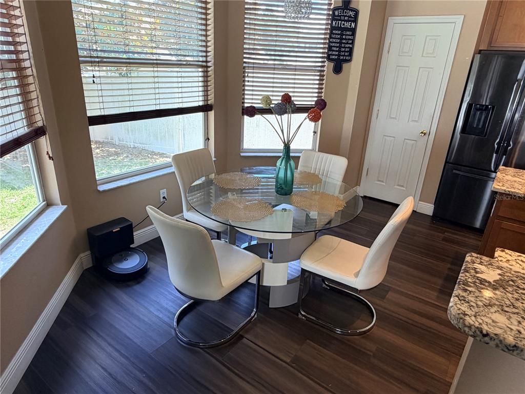 13250 Mandalay Place Spring Hill, FL 34609 - Photo 10 of 28 a dining room with furniture and wooden floor