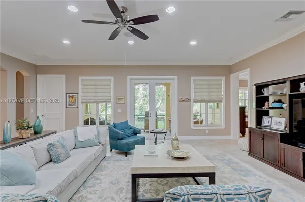 a living room with furniture ceiling fan and a window